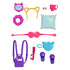 Barbie accessory collection with purple backpack, slippers, blue pillow, pink sleep mask, yellow cat-ear headband, and matching travel cup for doll styling.