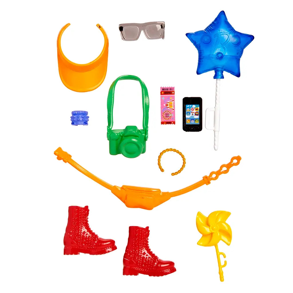 Barbie accessory set featuring orange visor, red boots, green camera, yellow pinwheel, smartphone, and star balloon, arranged for doll adventure play.