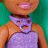 Close-up of Barbie Chelsea doll shows a molded lavender textured top with a purple unicorn necklace, paired with a colorful skirt and mint green hair cascading in the background.