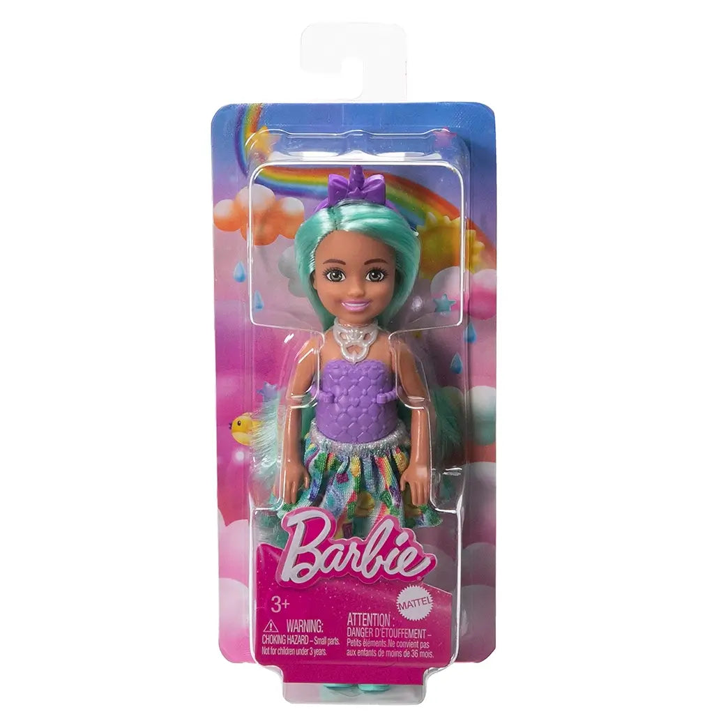 Barbie Chelsea unicorn-inspired doll with green hair is displayed in rainbow-themed Mattel packaging, showing her lavender outfit, turquoise boots, and purple horn headband.