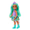Barbie Chelsea doll with flowing mint green hair wears a lavender unicorn top, rainbow skirt, turquoise boots, and purple unicorn horn headband, standing on a white backdrop.