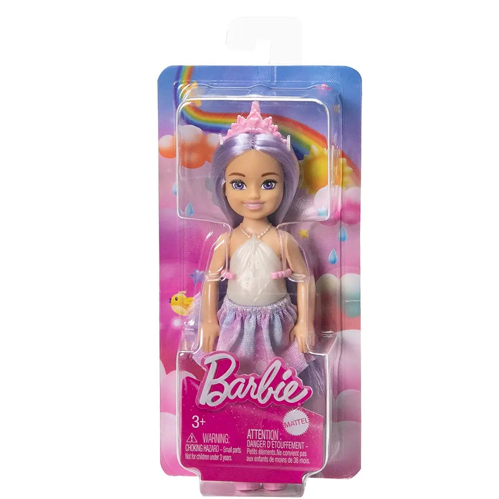 Barbie Chelsea doll in retail packaging, featuring lavender hair, pastel skirt, pink boots, rainbow and cloud background, and Barbie logo.