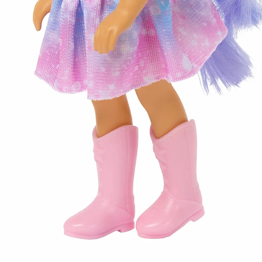 Close-up of Barbie Chelsea doll’s pink knee-high boots with subtle stitching details, worn with a pastel tie-dye skirt in pink and lavender shades.
