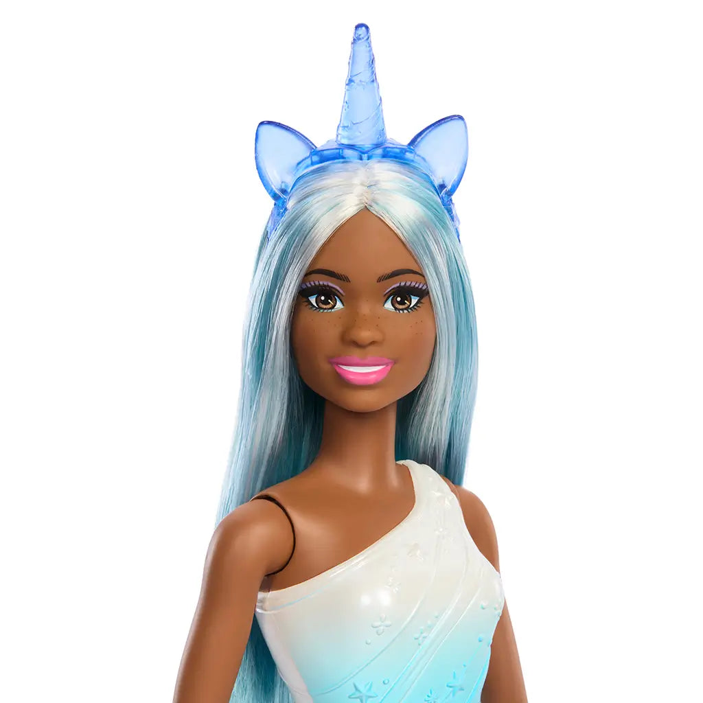 Close-up of Barbie unicorn doll’s face with pink lipstick, long pastel hair, and blue unicorn headband with translucent ears and horn.