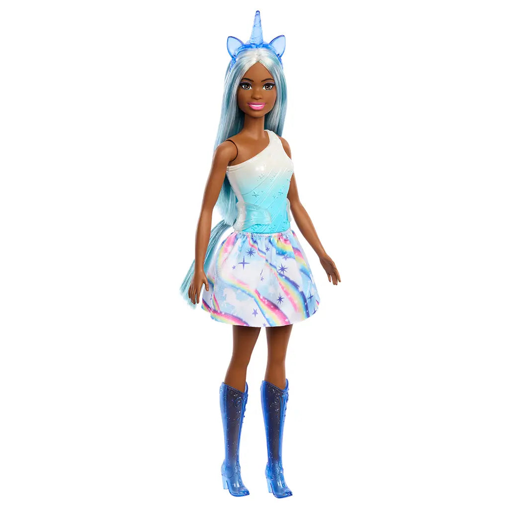 Full-body view of Barbie unicorn doll wearing a one-shoulder ombre top, rainbow skirt, translucent blue boots, and unicorn horn headband with long flowing hair.