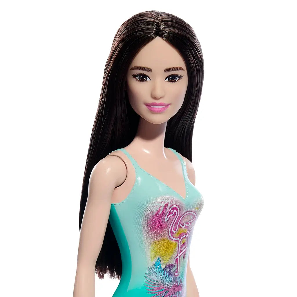 Closeup of a Barbie doll with a swimsuit featuring a flamingo design on a white background