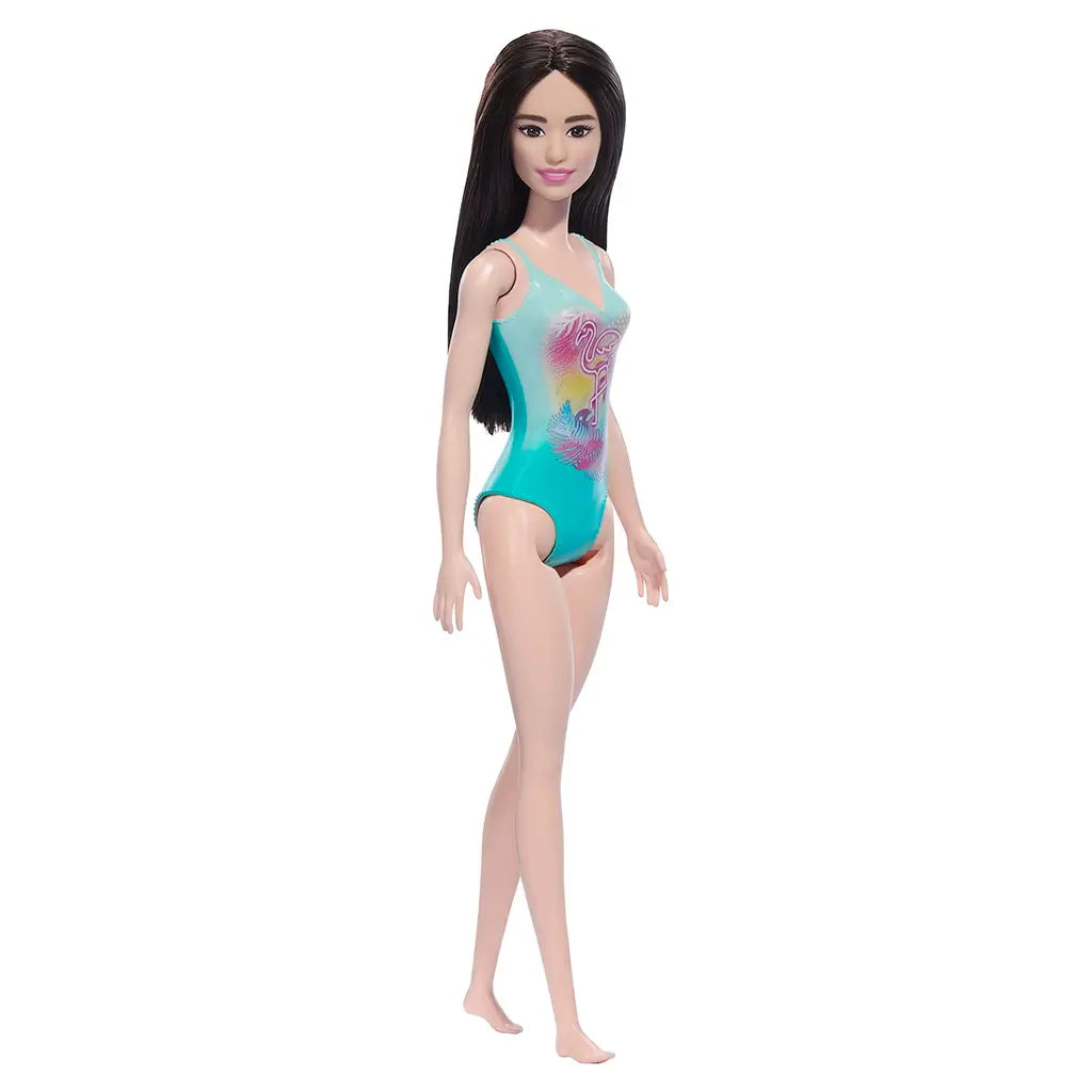Barbie doll with dark brown hair in a colorful teal swimsuit with a flamingo on a white background