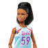 Close-up of Barbie basketball doll’s face, featuring detailed facial features, straight black hair in a high ponytail, and a sporty blue jersey with pink and purple accents.