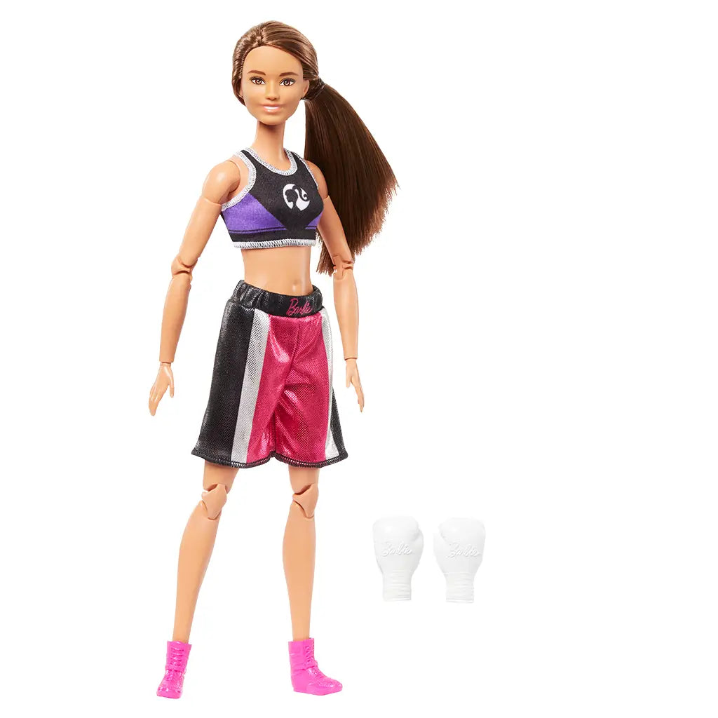 Barbie Made to Move boxer doll with long brown ponytail, dressed in boxing outfit with removable white gloves and pink boots, shown with accessories included.