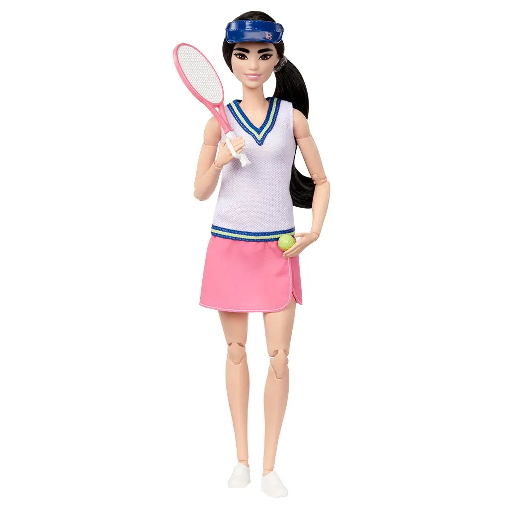Barbie tennis player doll front view, wearing white textured top, pink wrap skirt, and blue visor, holding racket in one hand and green tennis ball in the other.