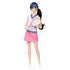 Barbie tennis doll posed standing, holding a pink racket and green ball, dressed in white sleeveless top with blue trim and pink skirt, ready for play.