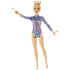 Barbie rhythmic gymnast doll posed holding silver gymnastic clubs, dressed in a sparkly purple and blue leotard, with hair styled in a sleek blonde bun.