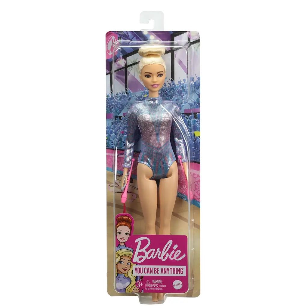 Barbie You Can Be Anything rhythmic gymnast doll in retail packaging, wearing a shiny purple and blue leotard with blonde hair in a bun, holding pink gymnastics clubs.