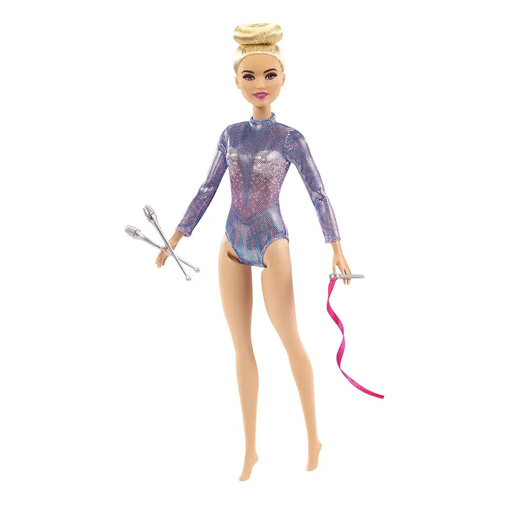 Barbie rhythmic gymnast doll with blonde hair in a bun, dressed in a sparkly purple-blue leotard, posed holding silver clubs and a pink ribbon accessory.