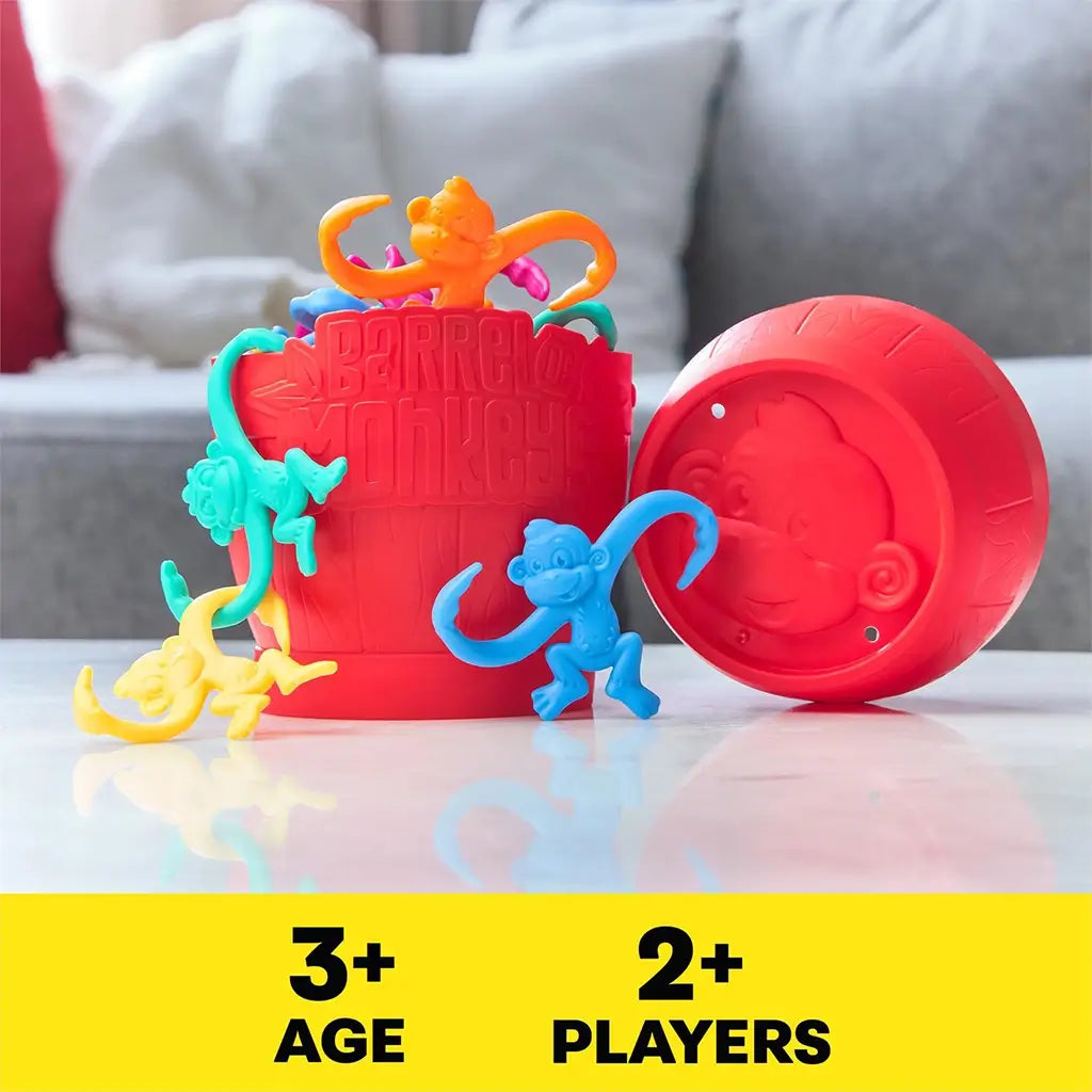 Close-up of the classic Barrel of Monkeys red barrel surrounded by colorful plastic monkeys in blue, yellow, orange, pink, and teal.