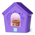 Bitzee interactive digital pet doghouse photographed from a three-quarter angle, emphasizing the purple plastic structure, sloped roof design, pixel-style surface texture, and glowing arched screen.