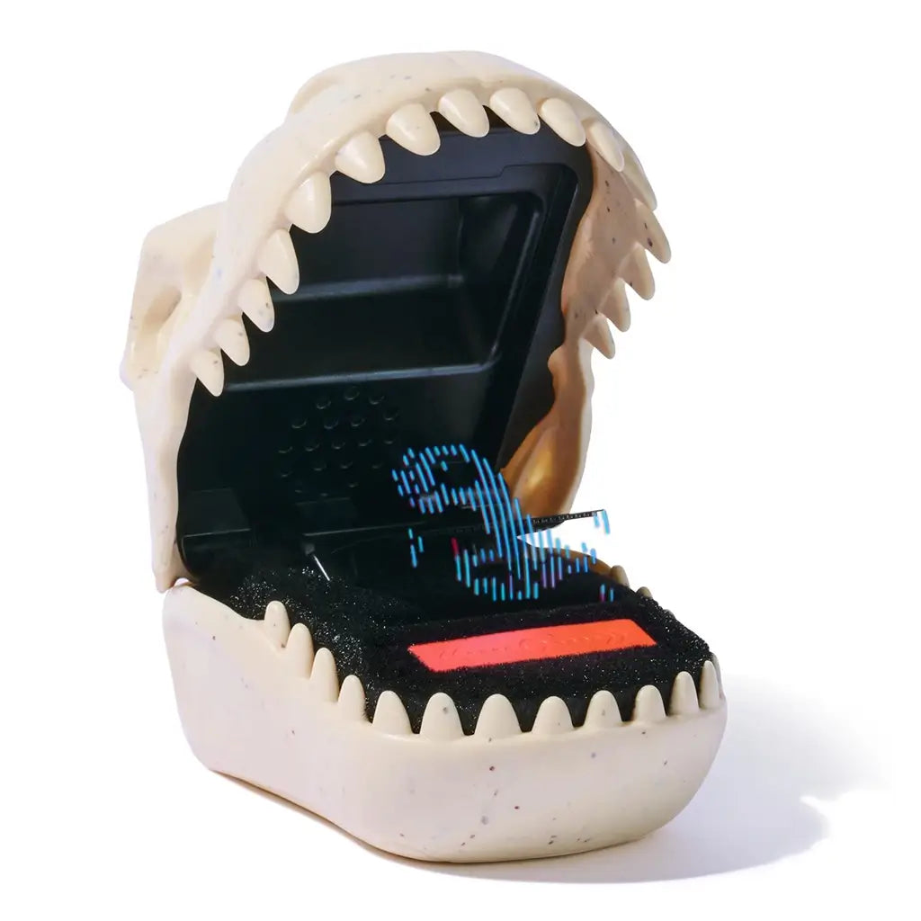Jurassic World Bitzee digital pet toy shown from an angled perspective, highlighting the beige textured dinosaur mouth shell, rounded teeth, and internal LED pixel dinosaur display against a white background.