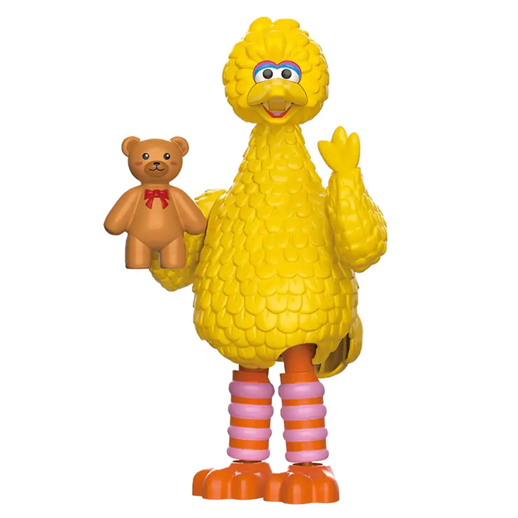 Blokees Sesame Street Big Bird collectible figure made of bright yellow plastic with detailed feathers, holding a teddy bear, and standing upright with orange feet and cheerful expression.