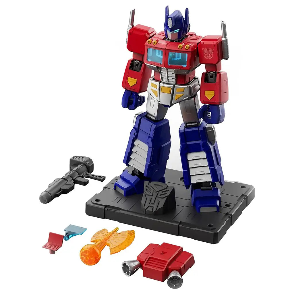 Blokees Transformers G1 Optimus Prime action figure with base and accessories including rifle, energy axe, and interchangeable parts, featuring red, blue, and silver detailing on a black display stand.