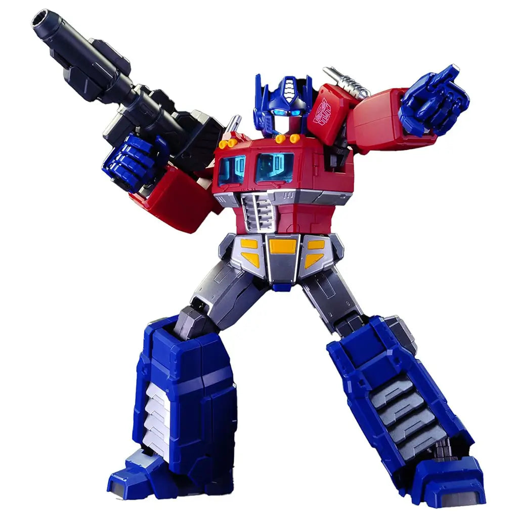 Blokees G1 Optimus Prime model figure posed dynamically with black blaster rifle raised, showing metallic armor texture, joint articulation, and vivid red and blue color scheme.