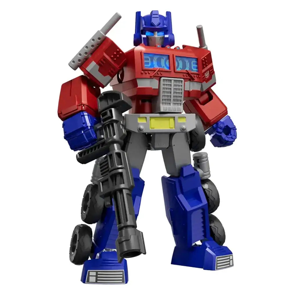Red, blue, and gray plastic Transformer robot toy with metallic detailing and large black blaster, posed standing upright on a white background, showcasing articulated limbs and mechanical features.