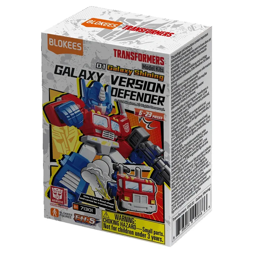 Blokees Transformers Galaxy Version Defender model kit box featuring red and blue robot figure artwork, toy truck image, and bold text with Hasbro logo, warning label, and 6–23 piece count details.