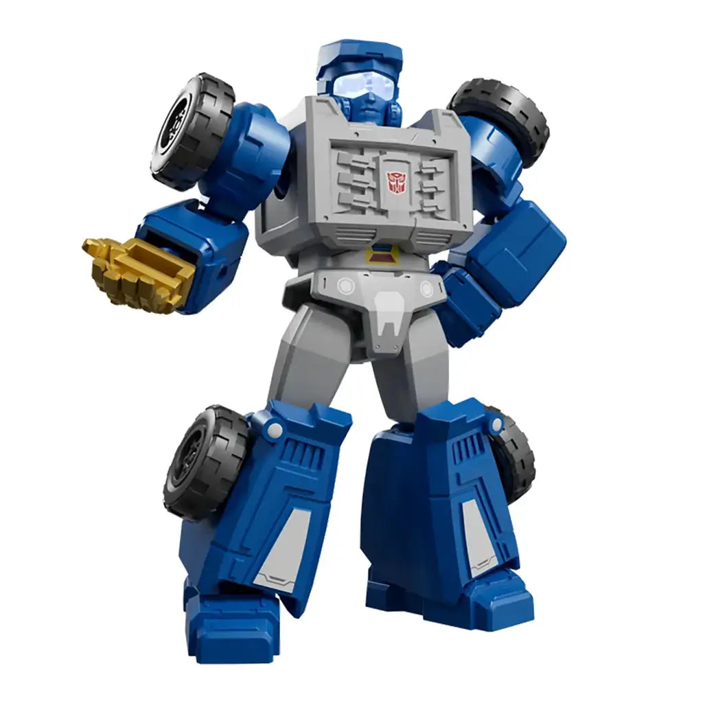 Blokees Transformers Shining 1985 blue and gray robot toy figure with gold hand and wheel accents, featuring a compact armored design.