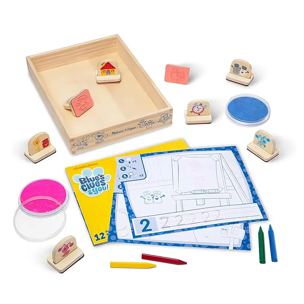 Complete Melissa & Doug Blue’s Clues & You! wooden handle stamps set with ink pads, tracing sheets, and character stamps of Blue and friends, designed to inspire imaginative drawing and storytelling play.