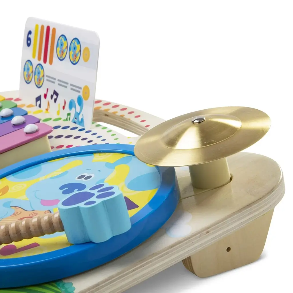 Close-up of Melissa & Doug Blue’s Clues & You! music maker board highlighting the shiny gold cymbal and bright xylophone keys, promoting fine motor skills and musical creativity for young learners.