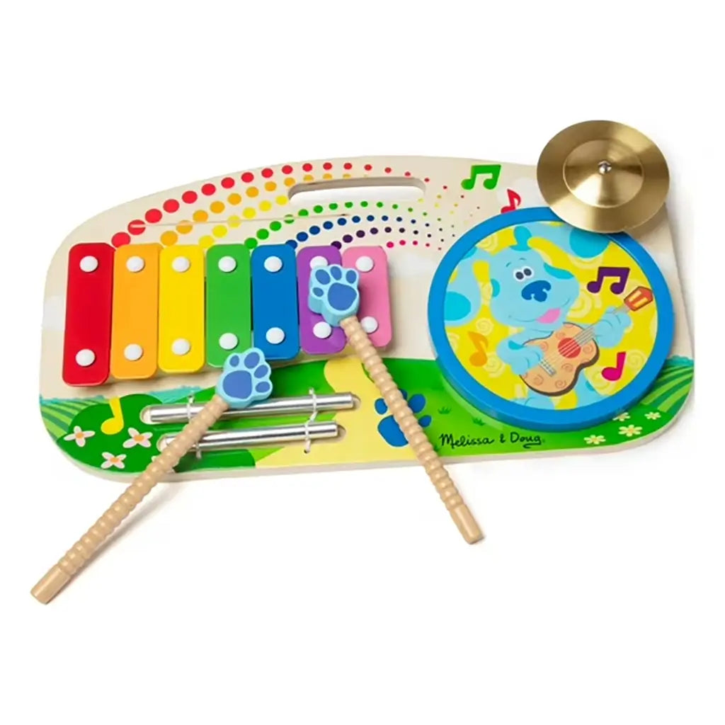 Melissa & Doug Blue’s Clues & You! wooden music maker board featuring a colorful xylophone, drum, and cymbal with Blue the dog illustration, encouraging rhythm and sensory exploration for kids.