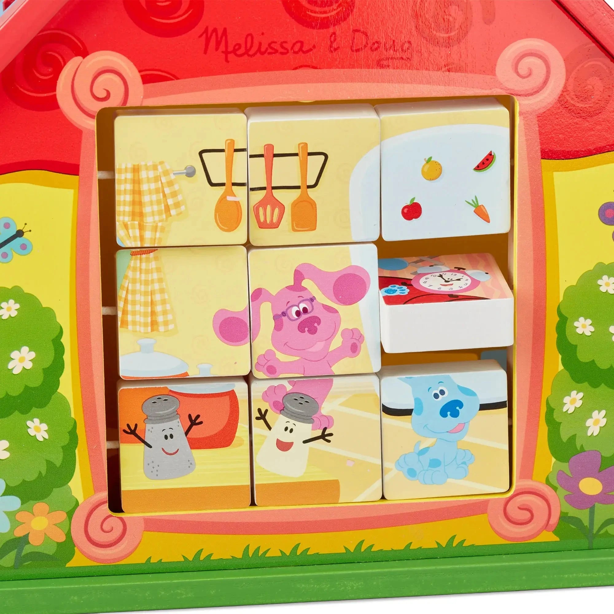 Close-up of Blue’s Clues take-along house puzzle showing rotating wooden blocks with characters like Blue, Magenta, Salt, and Pepper in a colorful kitchen scene.