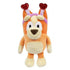 Smoochy Kiss Bingo plush toy in orange and cream fabric features a rounded dog shape with soft velvety texture and a pink headband topped with glittery red heart antennae, posed clearly on a white background.