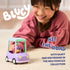 Child smiling while pushing the Bluey Granny Car toy with Janet figure inside, demonstrating scale, easy-rolling wheels, and hands-on imaginative play indoors.