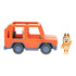 Bluey Heeler Family 4WD toy vehicle is shown beside the poseable Chilli figure, featuring an orange open-frame body, blue wheels, molded seats, and smooth plastic surfaces on a white background.