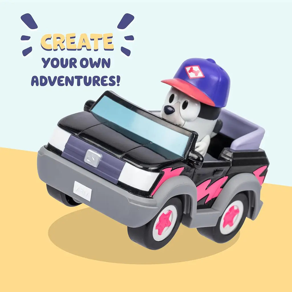 Bluey Muffin character figure close-up, white and gray cartoon dog with rounded plastic body, blue mechanic-style hat and simple facial details, standing upright against a clean white background.