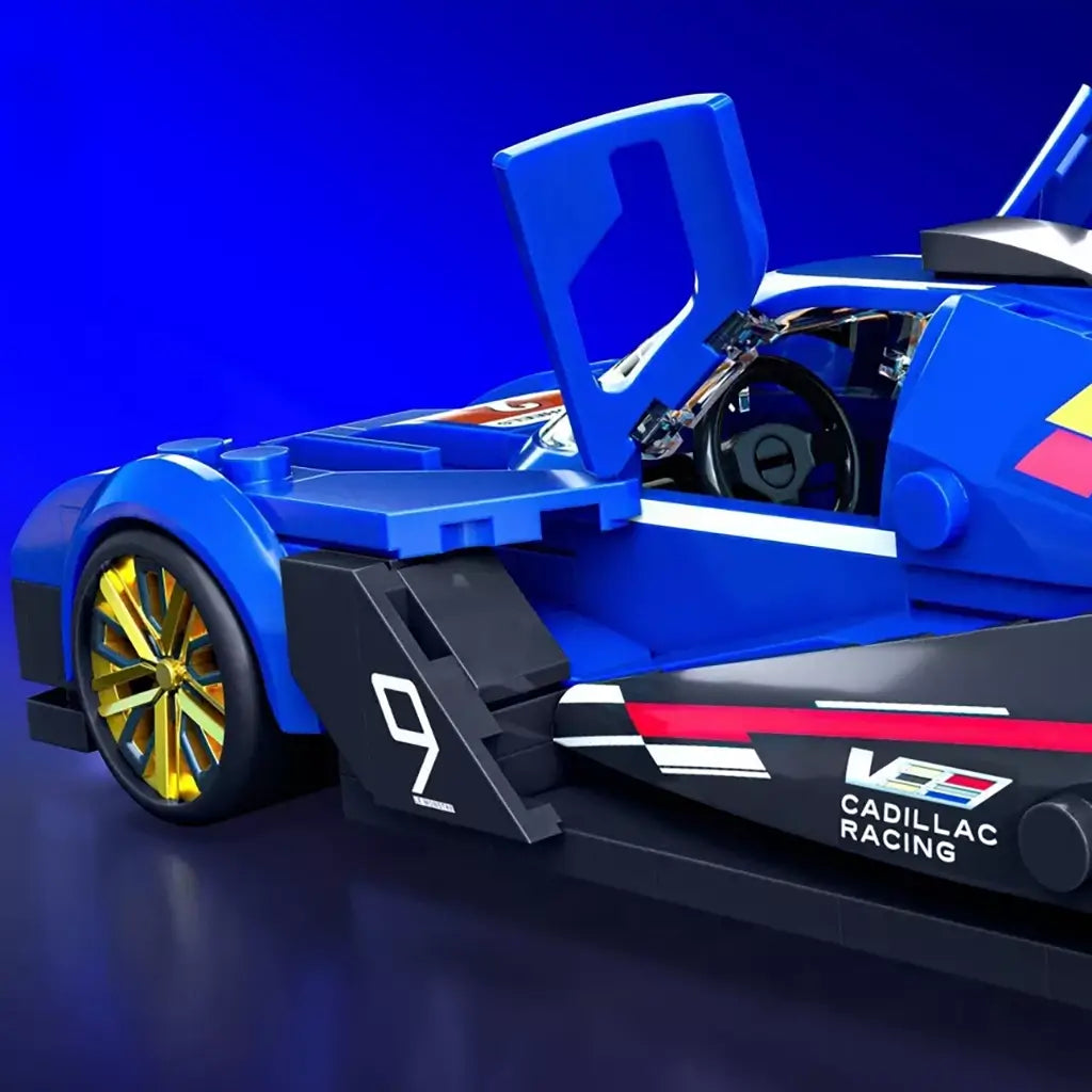 Hot Wheels Cadillac Project GTP Hypercar in blue plastic bricks shows an open working door, gold wheel, cockpit details, and Cadillac Racing graphics on a blue backdrop.