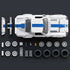 Hot Wheels Corvette Grand Sport building set parts laid out neatly, featuring white and blue plastic bricks, wheels, tires, accessories, and body panels arranged around the completed car on a dark surface.