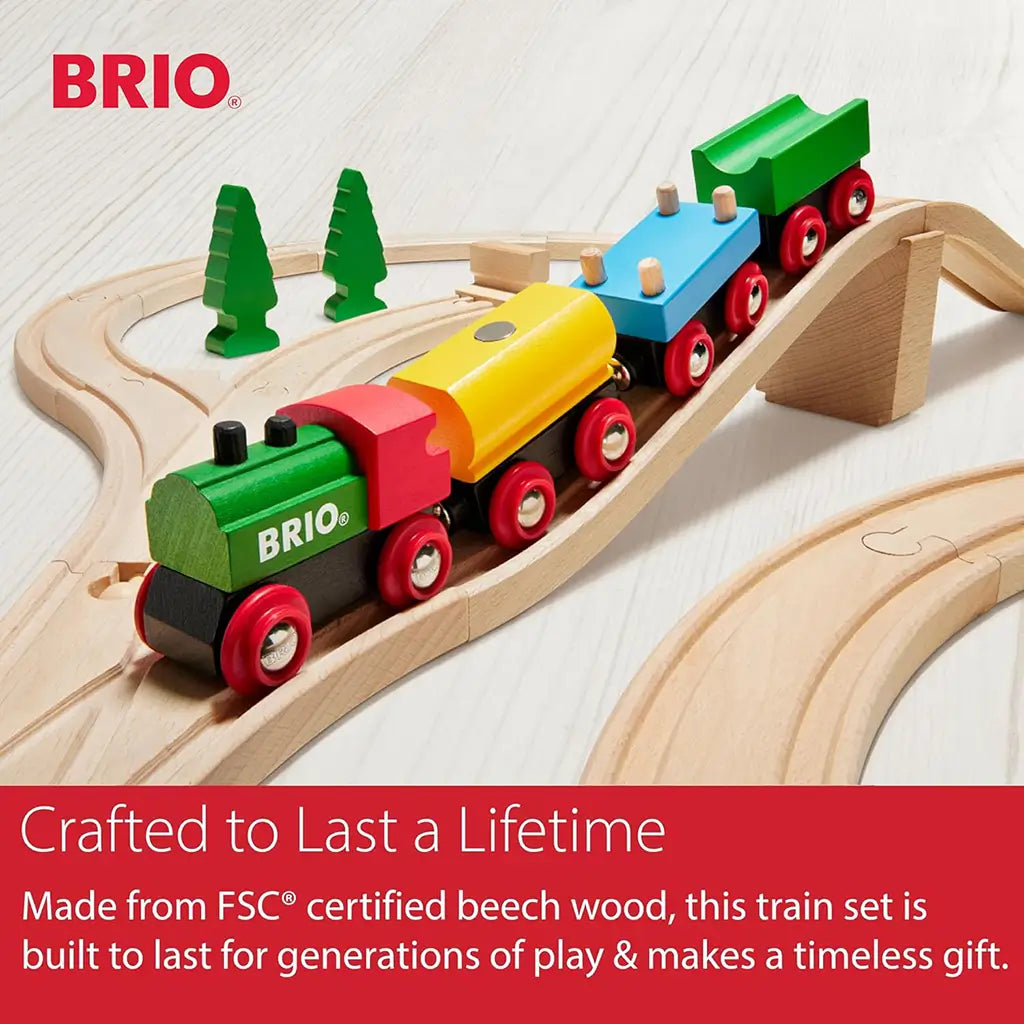 Close-up of BRIO 65th Anniversary wooden train with red, green, blue, and yellow wagons on wooden track, highlighting FSC-certified beech wood and durable design.