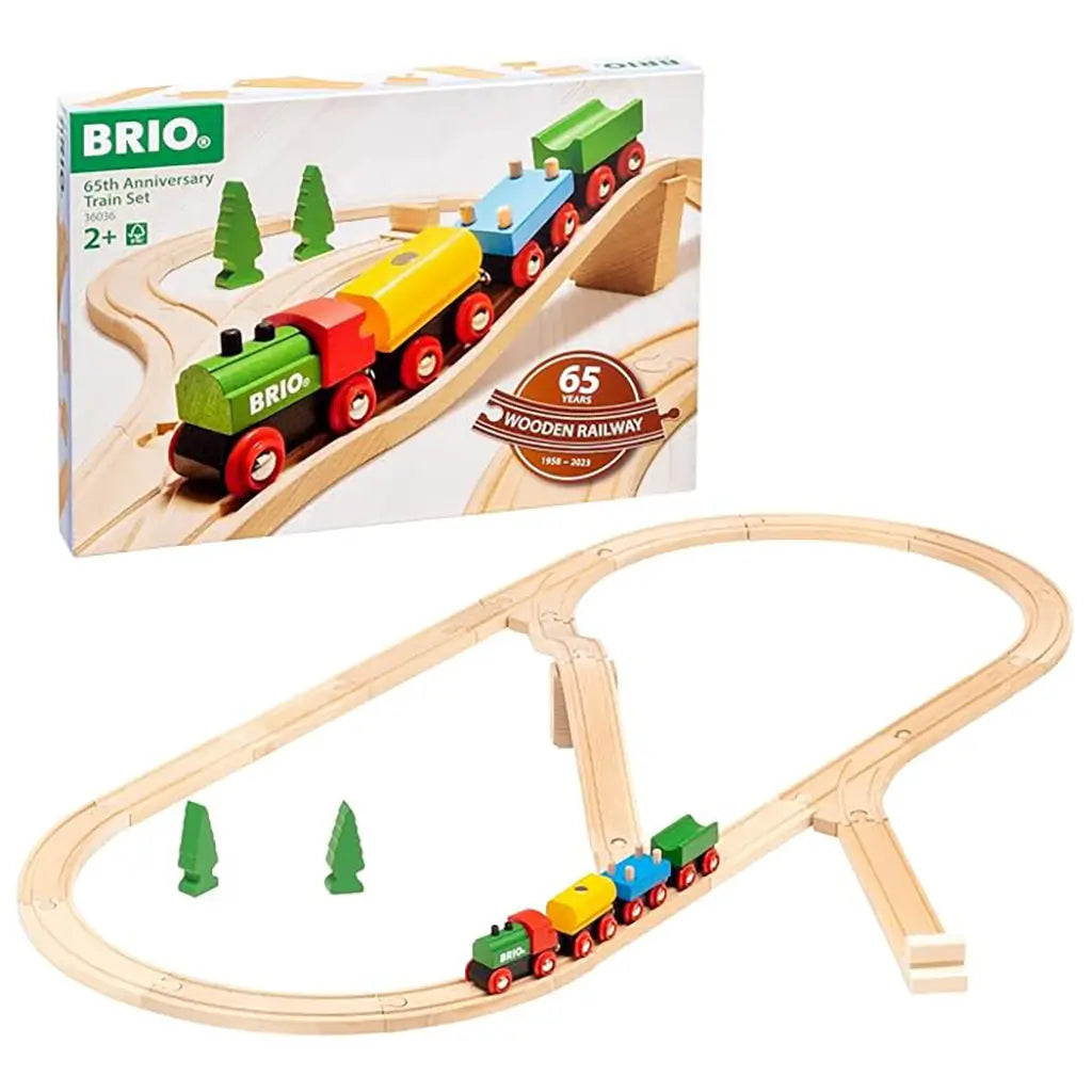 BRIO 65th Anniversary Train Set packaging showing colorful wooden train climbing bridge, anniversary logo, and assembled wooden railway track with trees.