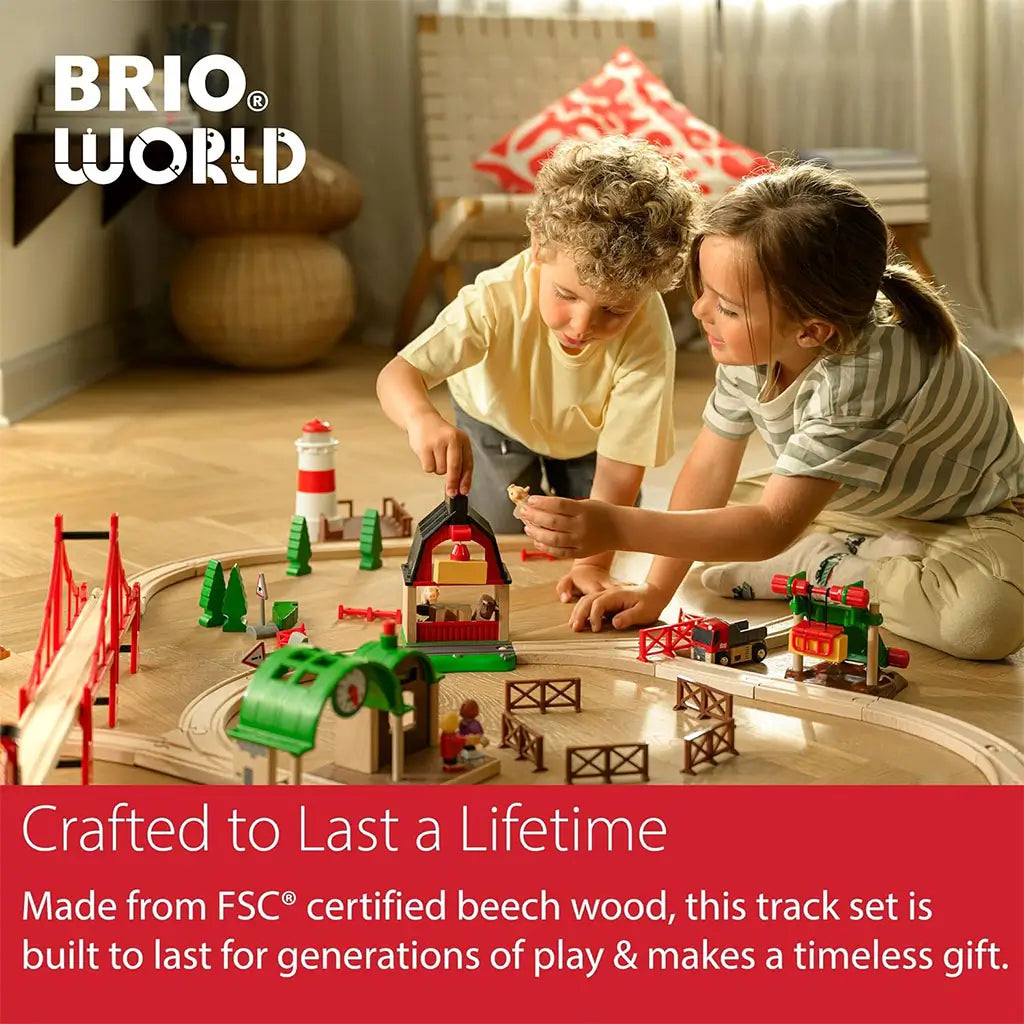 Two children playing on the floor with a BRIO wooden railway set, showcasing FSC-certified beech wood tracks, colorful accessories, and imaginative play in a cozy living room.