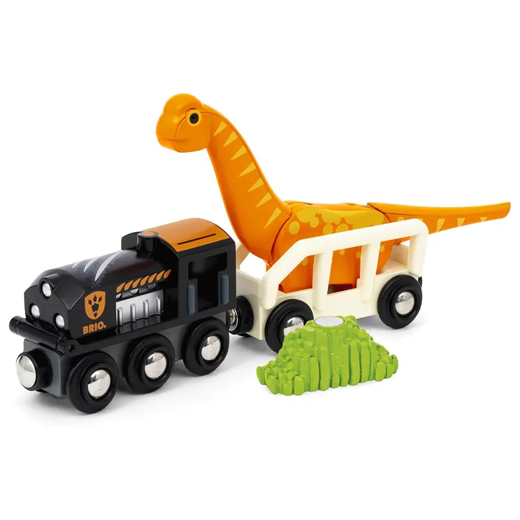 BRIO Dinosaur Circle Train Set train connected to white wagon carrying orange brachiosaurus toy, with magnetic foliage accessory displayed in front on white background.