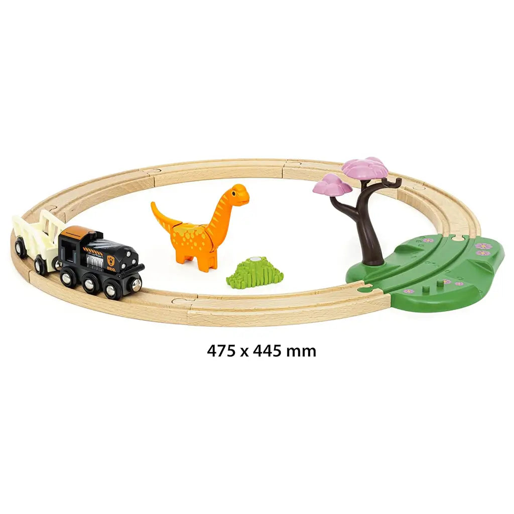 Assembled BRIO Dinosaur Circle Train Set measuring 475 x 445 mm, featuring circular wooden track with dinosaur, foliage, tree, and train engine with wagon.
