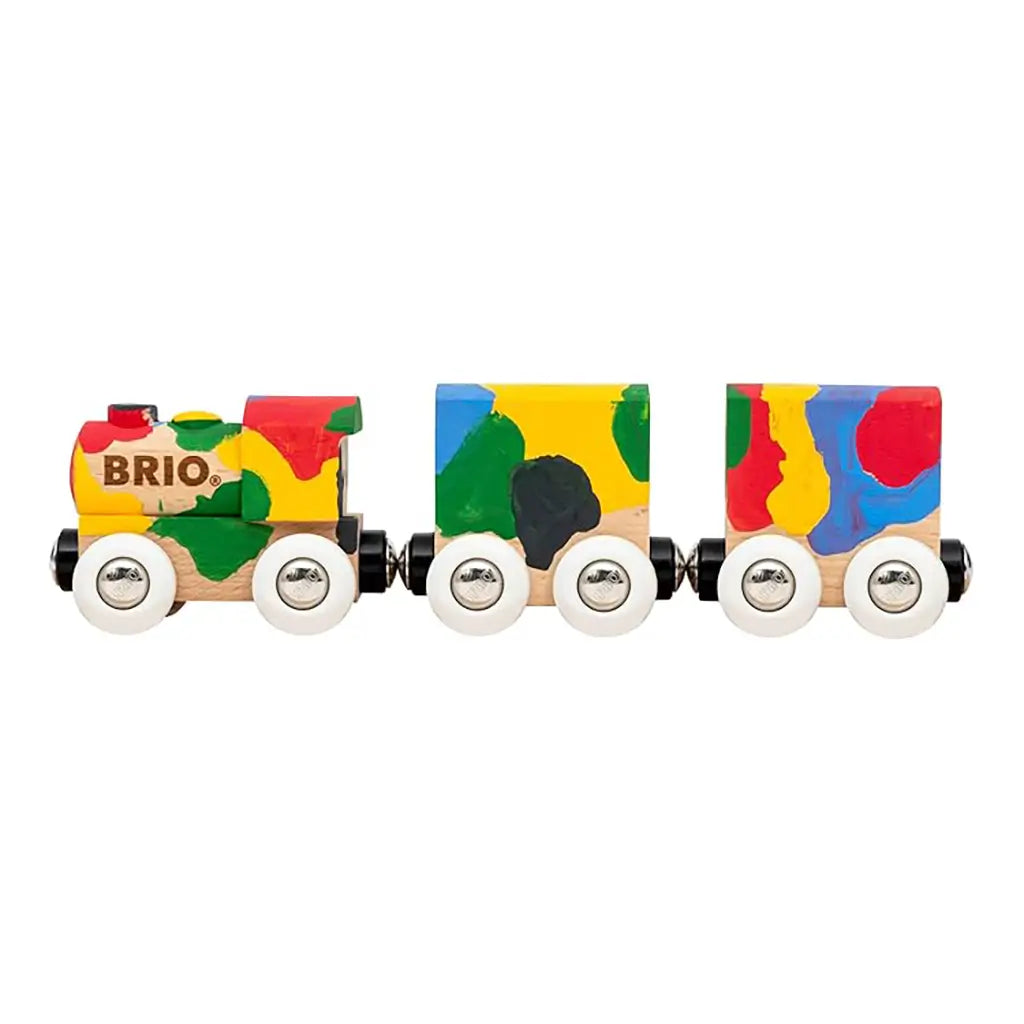 Finished BRIO Paint Train set with three wooden cars fully painted in bold red, green, blue, yellow, and black colors, connected and ready for imaginative play.