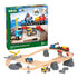 BRIO World rail and road loading set packaging with assembled wooden track, trucks, crane, and train, recommended for children ages 3 and up for interactive play.