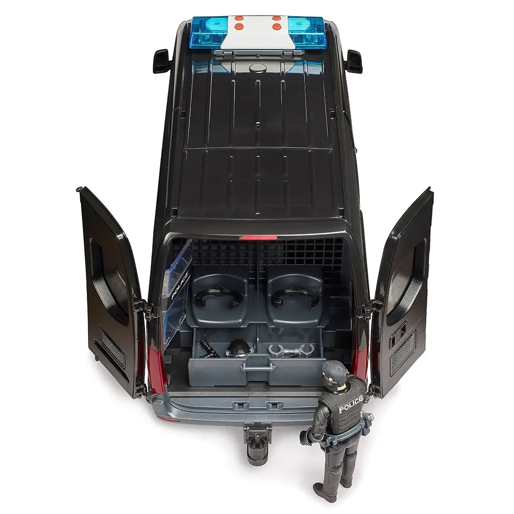Bruder Mercedes-Benz Sprinter police van toy in black plastic with gray and blue details, featuring open rear doors, holding-cell seats, gear, and police figure on white.