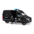 Bruder Mercedes-Benz Sprinter police van toy in black plastic with gray and blue details, featuring an open sliding door, police figure, clear riot shield, and handcuffs on white.