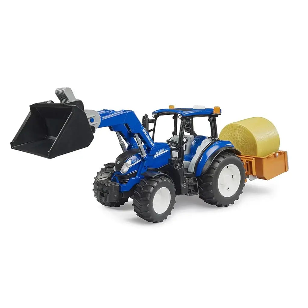Detailed New Holland T5.120 1:16 scale blue toy tractor with black bucket loader and orange rear box holding a rolled hay bale, shown on a white background to highlight farming equipment realism.