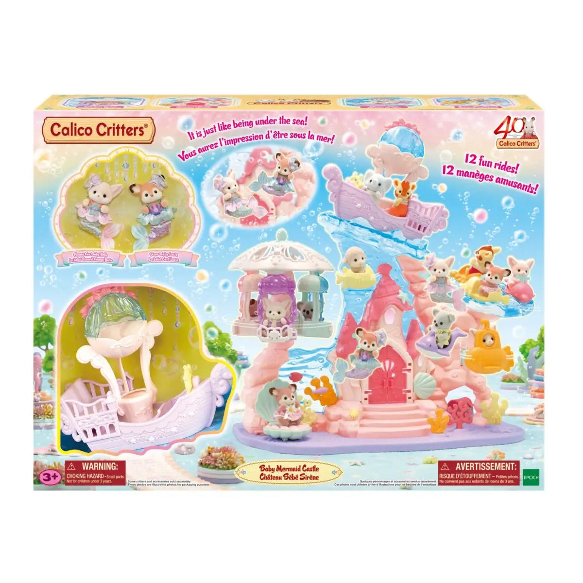 Calico Critters Baby Mermaid Castle set shows pastel pink plastic castle with ocean rides, wave slide, and carousel illustrated on retail box with sea themed graphics and character images.