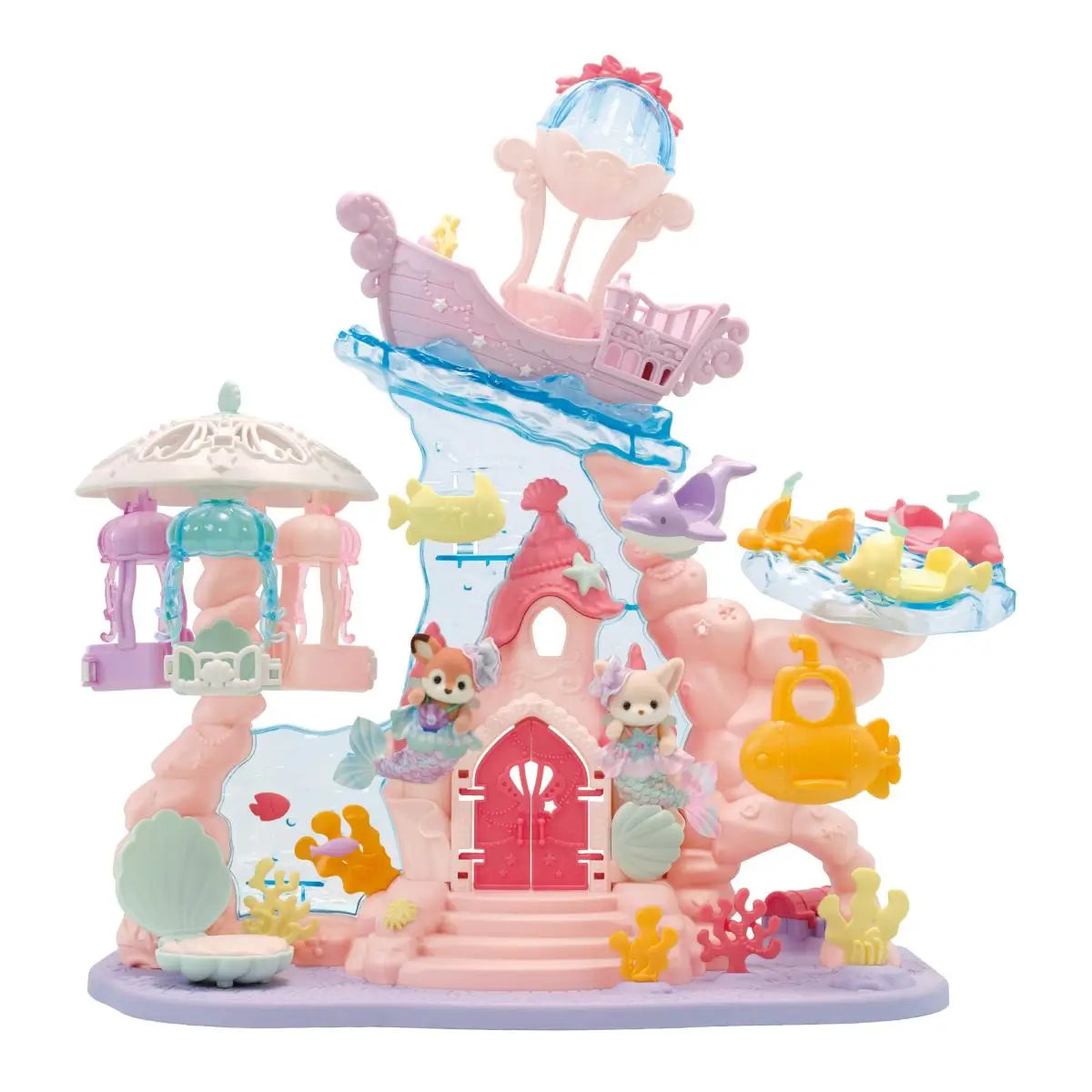 Calico Critters Baby Mermaid Castle toy includes pastel pink and purple plastic structure with blue water slide, shell accents, carousel canopy, and submarine ride on white background.