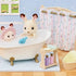 Calico Critters bath set display with white rabbit figurines in a white clawfoot tub, pastel shower curtain, soap bottles, towel basket, and toy fish in a dollhouse bathroom scene.